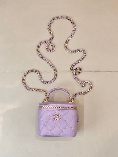 Chanel mini quilted lavender handbag with top handle, chain strap, and gold CC clasp