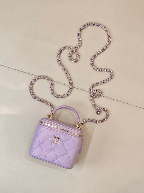 Chanel lavender quilted mini bag with top handle, long chain strap, and zip closure