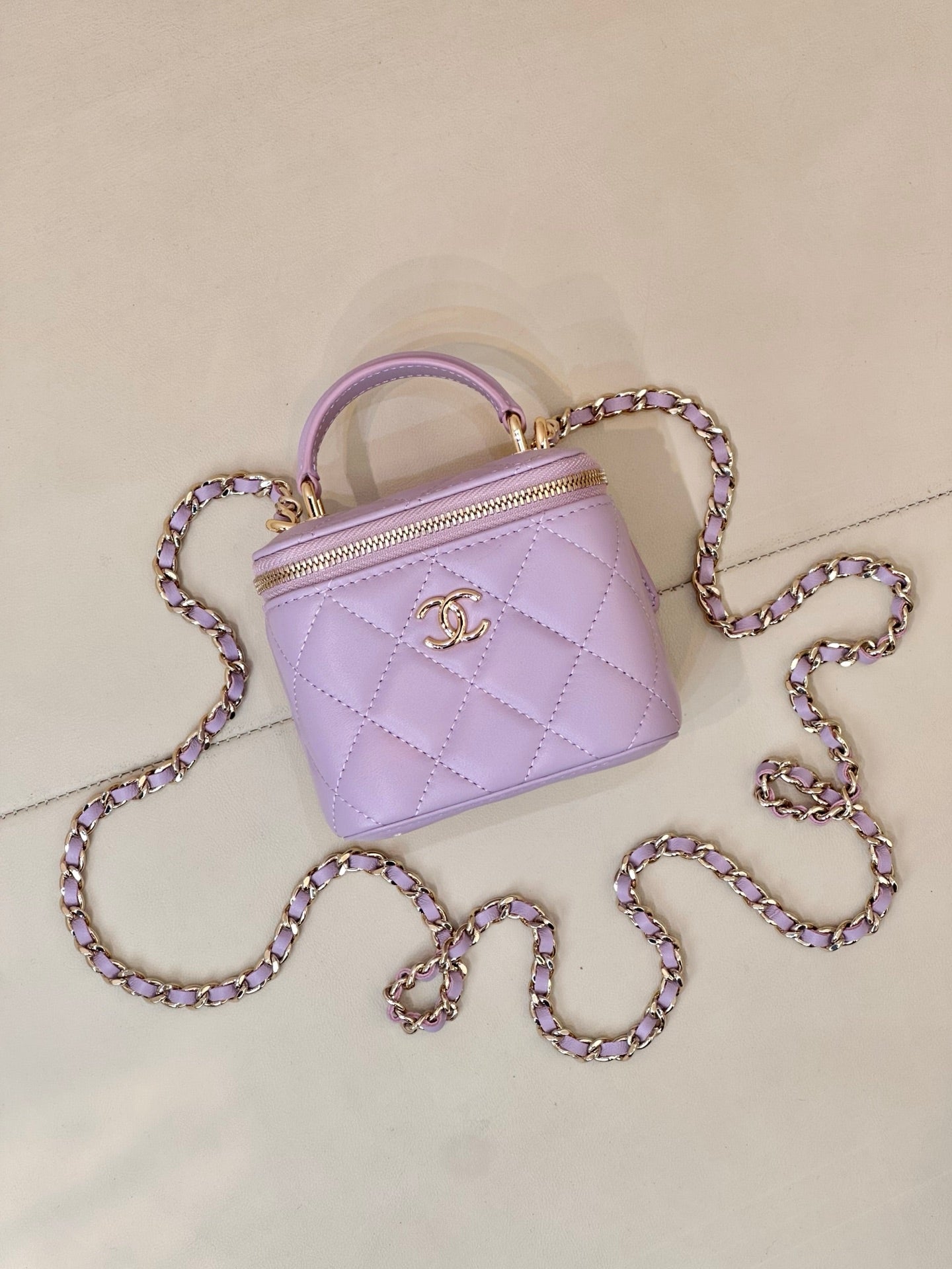 Chanel lavender quilted zip-top mini bag with top handle and purple-tinted chain strap