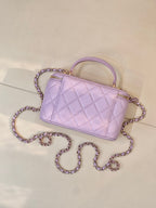 Lavender Chanel quilted handbag with gold-tone zipper, CC clasp and long chain strap