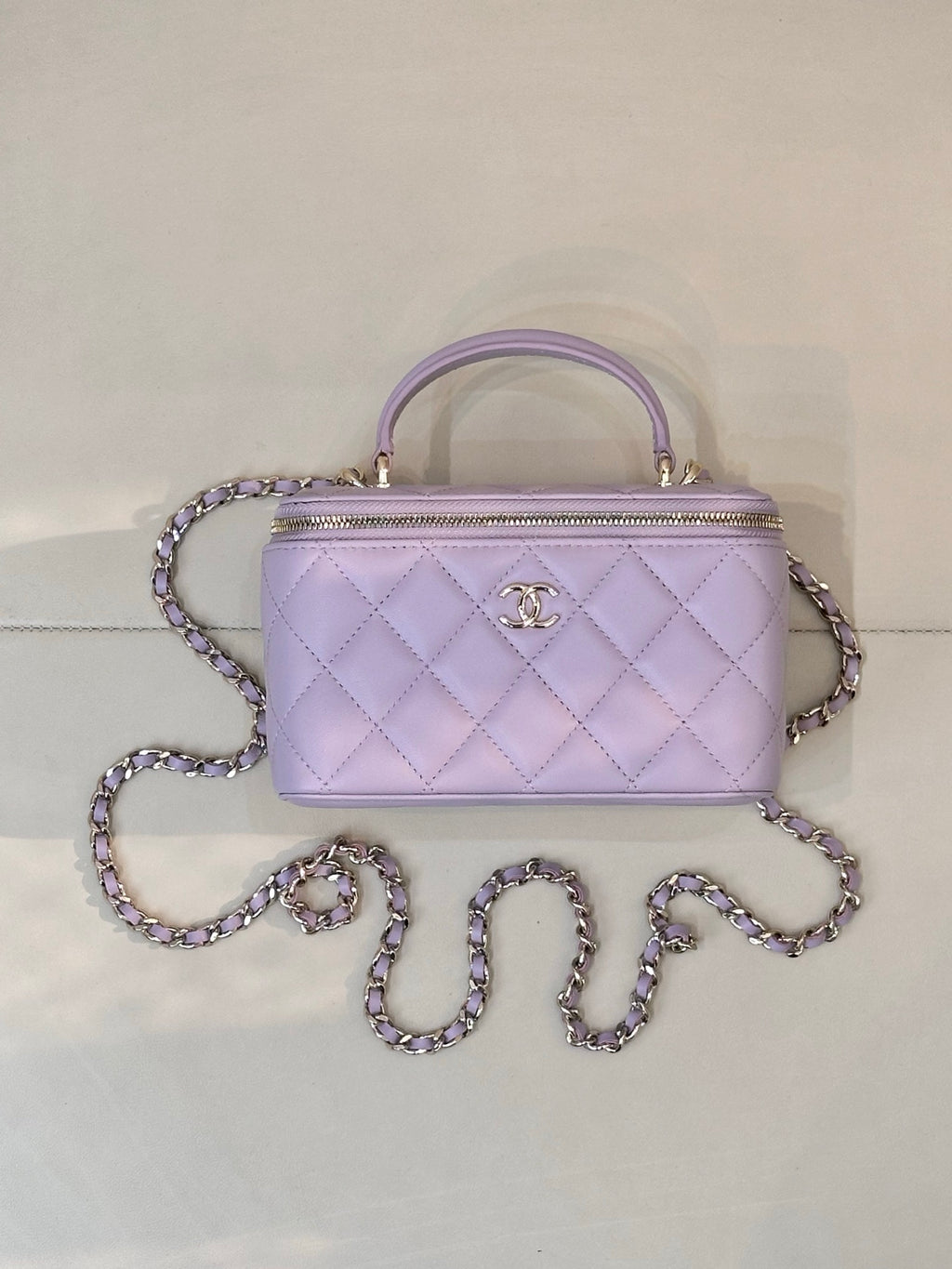 Lavender Chanel quilted handbag with gold-tone zipper, CC clasp, top handle and chain strap