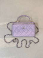 Lavender Chanel quilted handbag with gold-tone zipper, CC clasp, top handle and chain strap