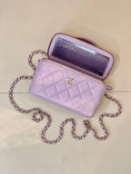 Lavender Chanel quilted bag with open top, gold-tone CC clasp, chain strap