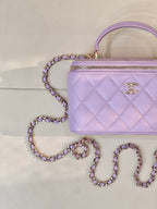 Lavender Chanel quilted bag front with gold-tone CC clasp, top handle and chain strap
