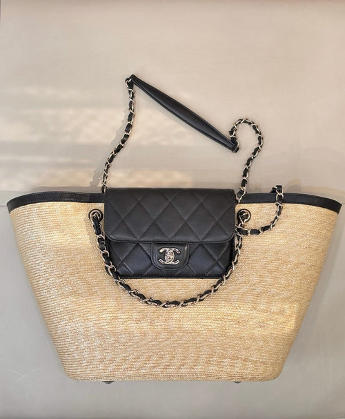 Beige woven tote bag with black trim, chain handles, and quilted flap mini bag