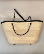 Beige woven tote bag with black top trim and chain tote handles