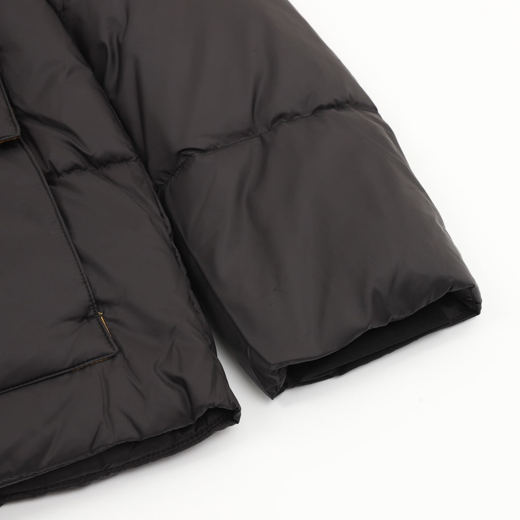 Black quilted puffer jacket sleeve and hem with folded cuff edge