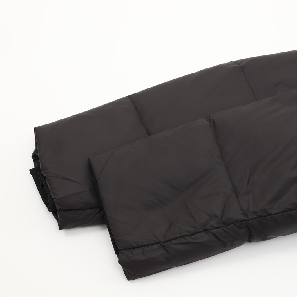Black puffer jacket lower hem with quilted padding