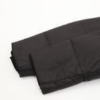 Black puffer jacket lower hem with quilted padding