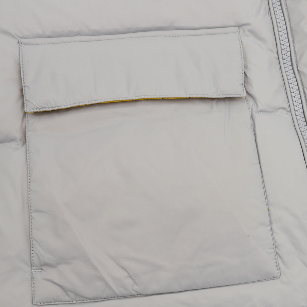 Puffer jacket front pocket panel with stitched edge, light gray fabric