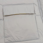 Puffer jacket front pocket panel with stitched edge, light gray fabric