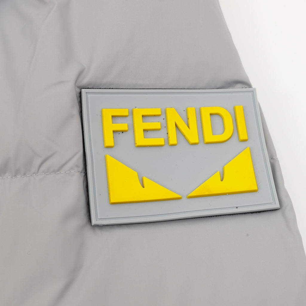 Puffer jacket patch with FENDI yellow emblem on light gray fabric