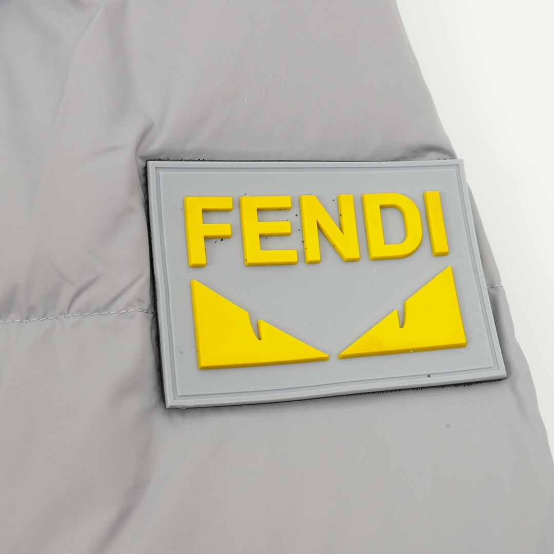 Puffer jacket patch with FENDI yellow emblem on light gray fabric