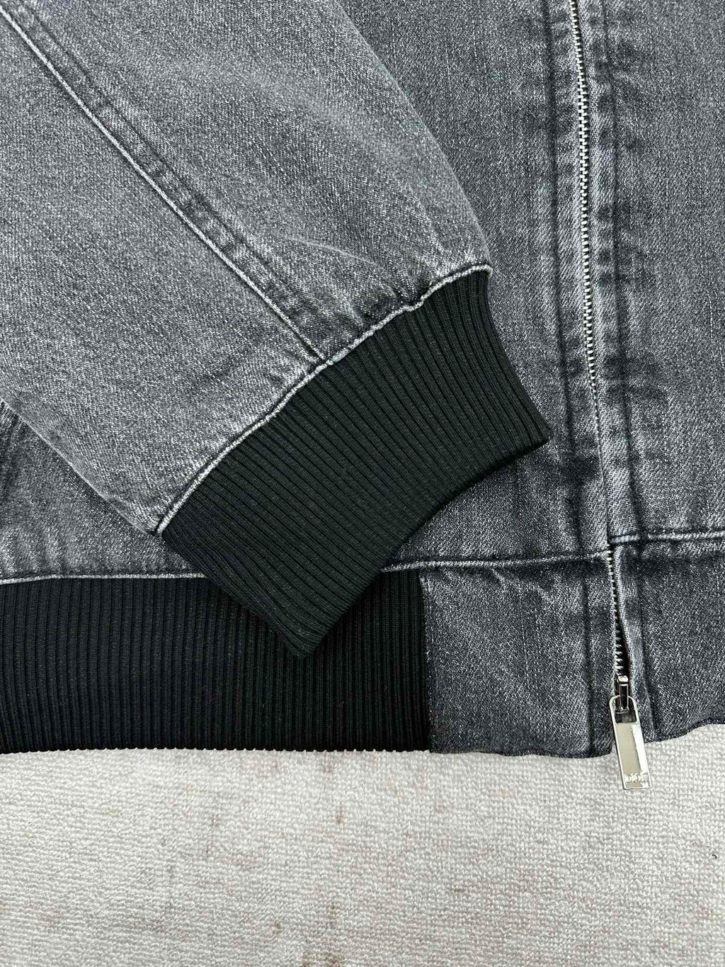 Dior denim jacket cuff with ribbed knit trim and zipper detail