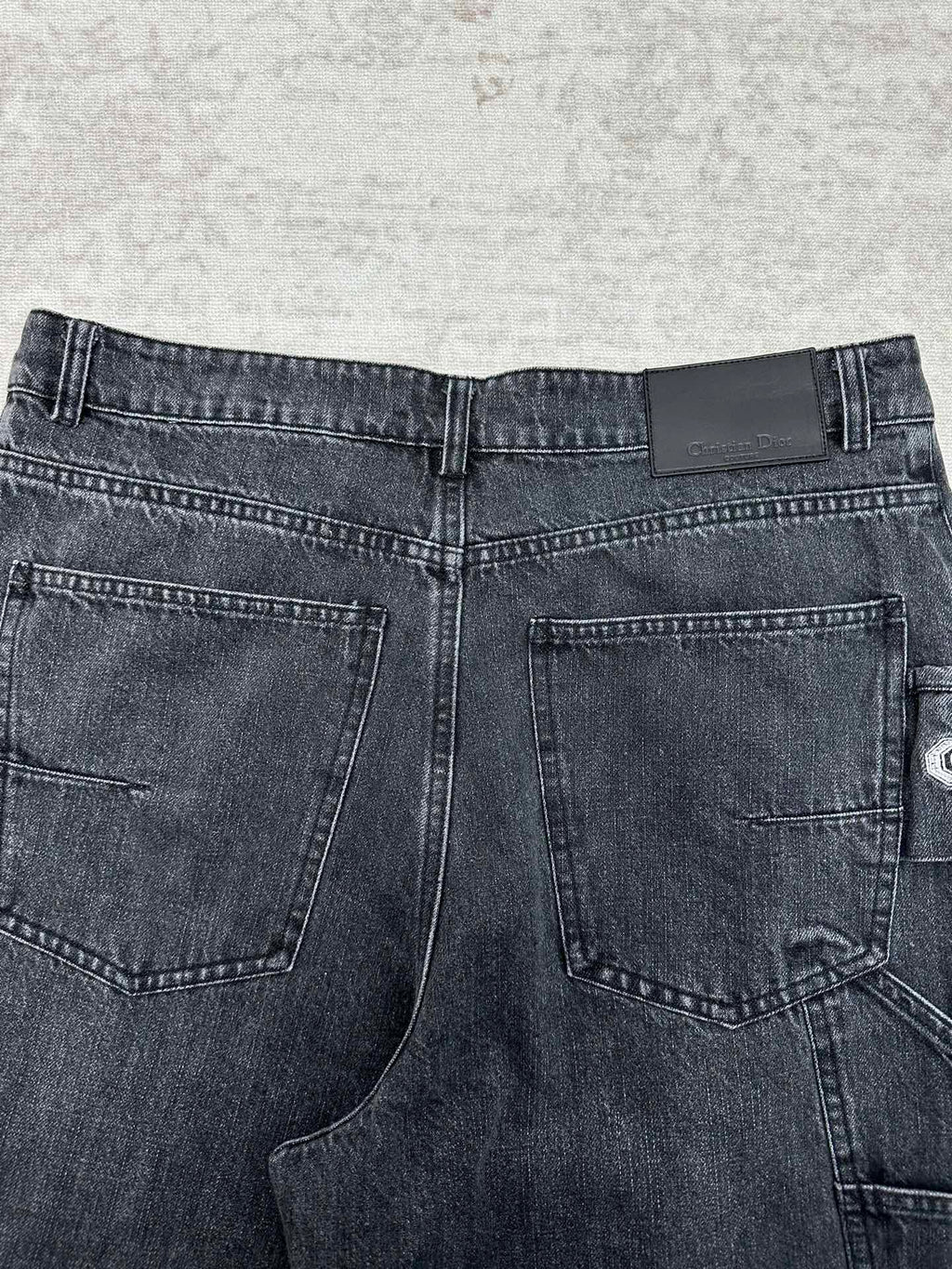 Dark blue denim pants front with two patch pockets and belt-loop waistband