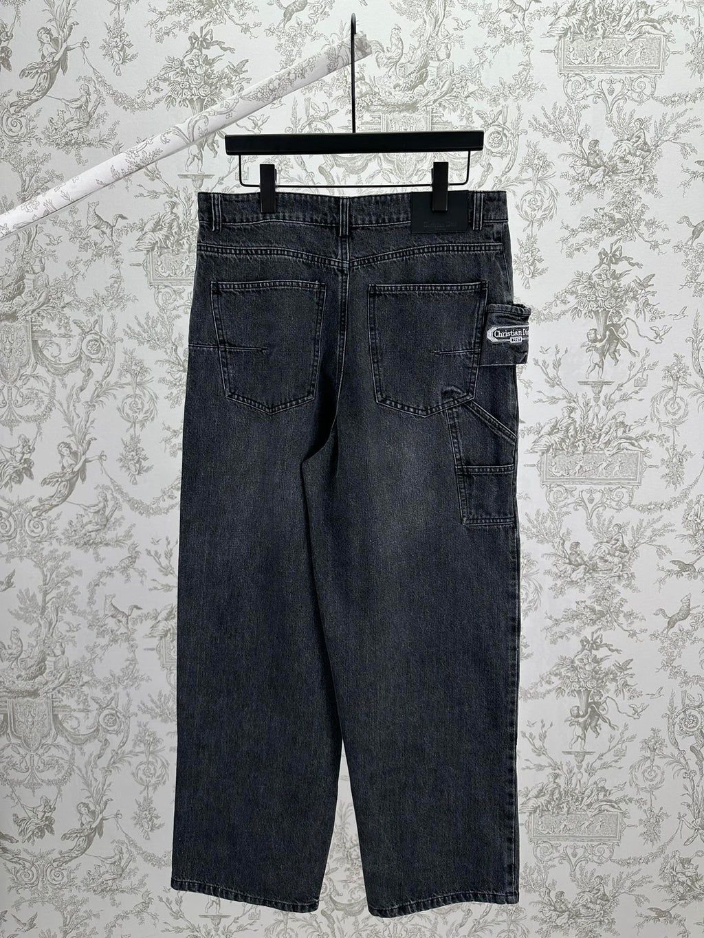 Dark blue denim pants with back yoke, patch pockets, and belt-loop waistband