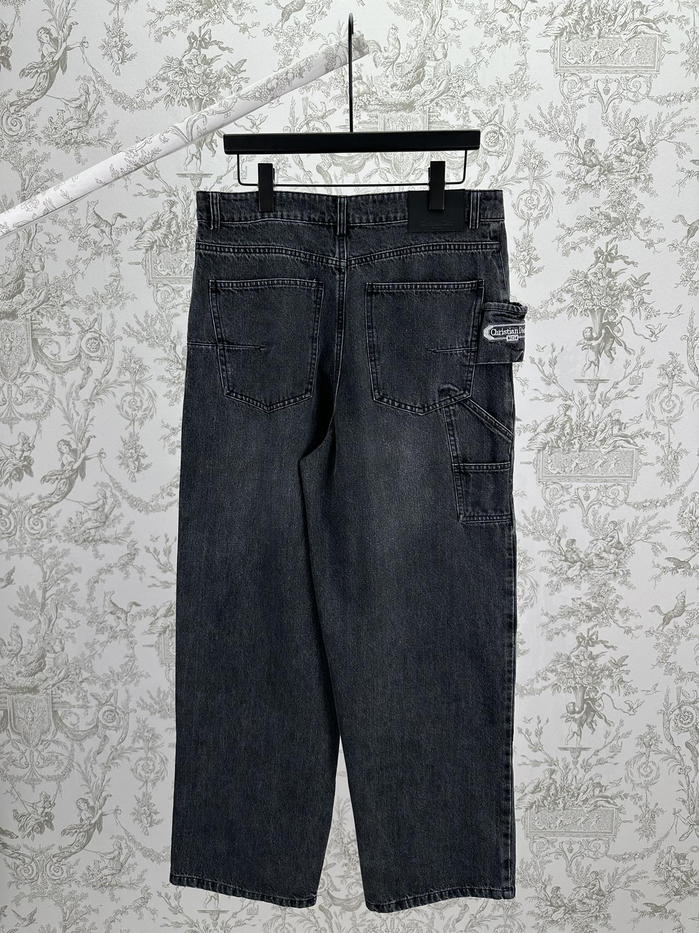 Dark blue denim pants with back yoke, patch pockets, and belt-loop waistband