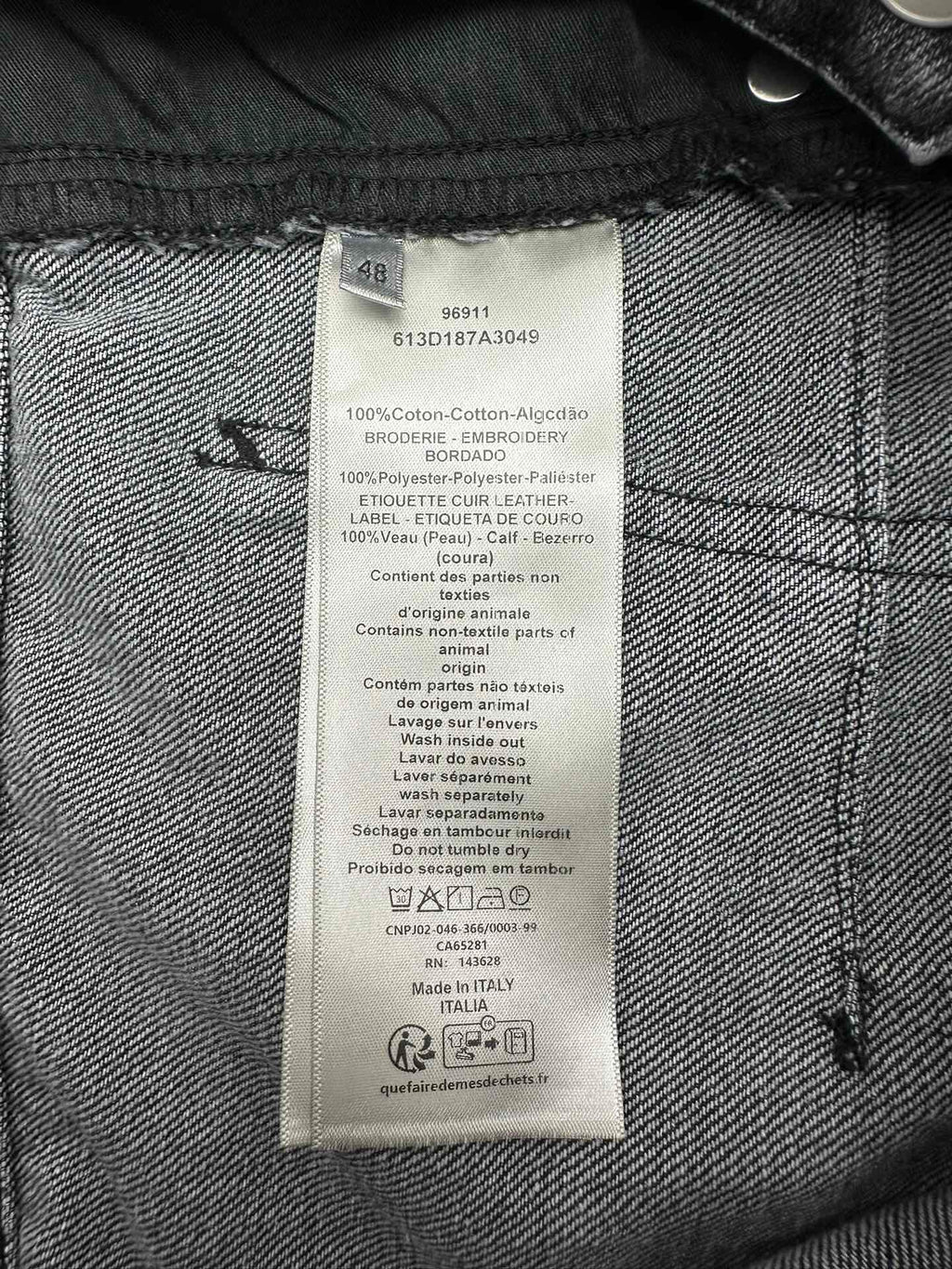 Inside denim label with size and care instructions, including cotton blend text