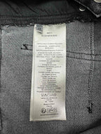 Inside denim label with size and care instructions, including cotton blend text
