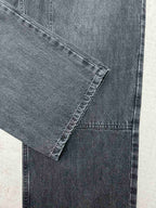 Denim cuff and front leg seam detail with visible stitching