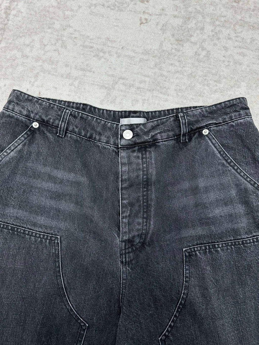 Denim pants waistband with button closure, belt loops, and front pockets