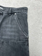 Denim pants side view with angled seam and stitched hems at the cuff