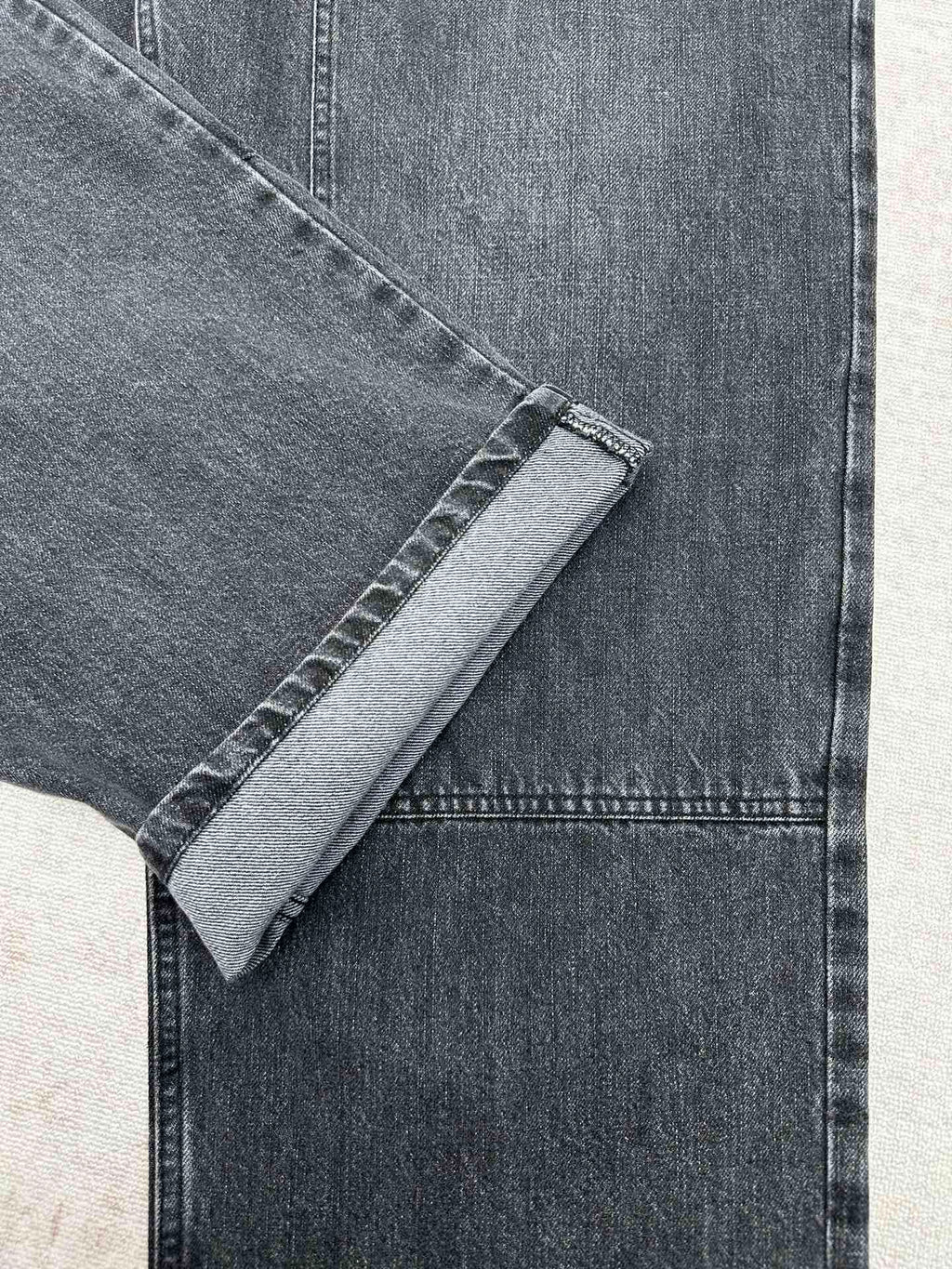 Denim pant hem cuff and topstitching detail on the leg
