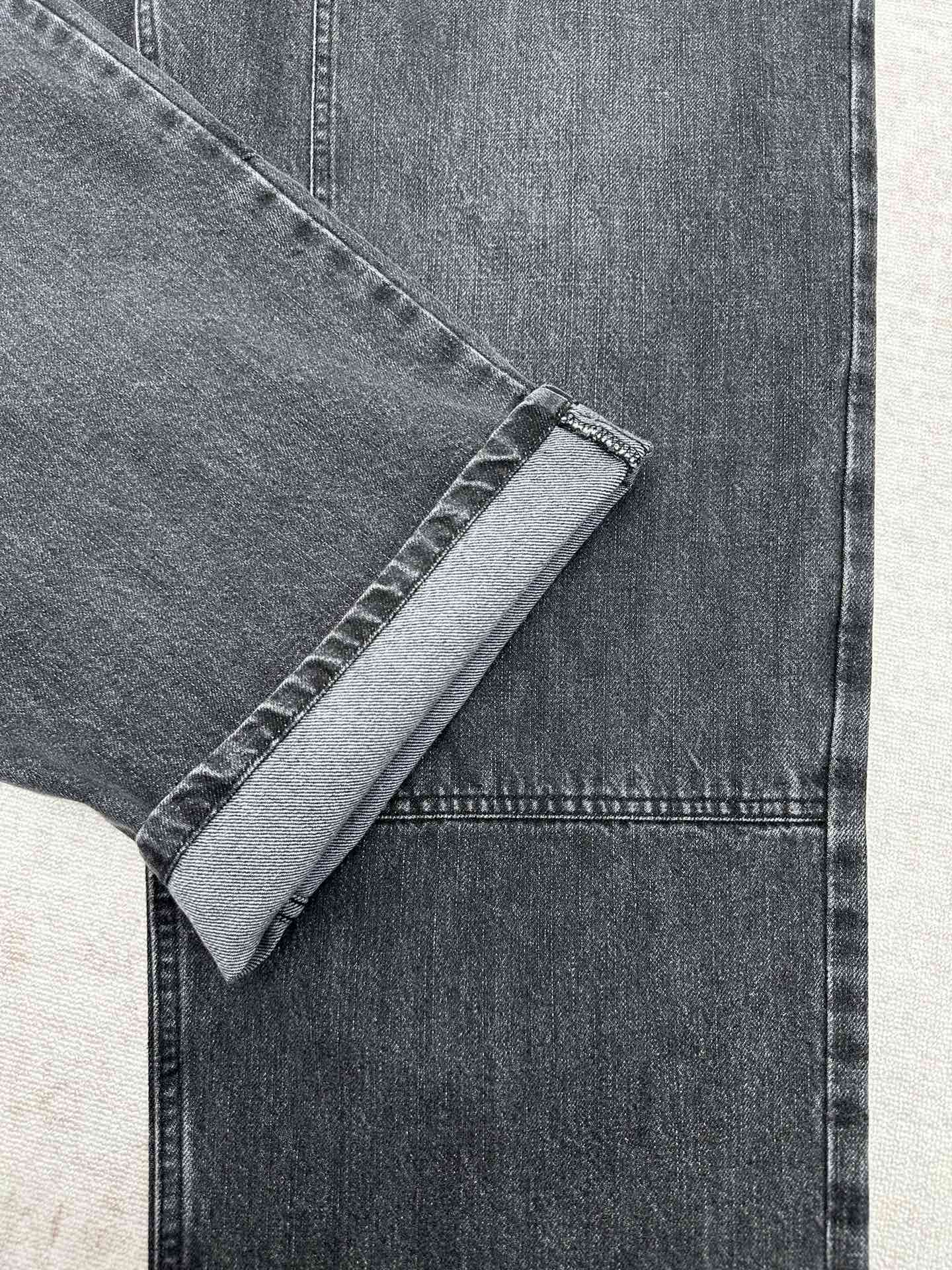Denim pant hem cuff and topstitching detail on the leg