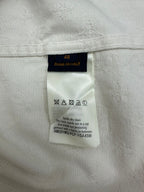 Long white jacket interior care label with size 48 and washing symbols