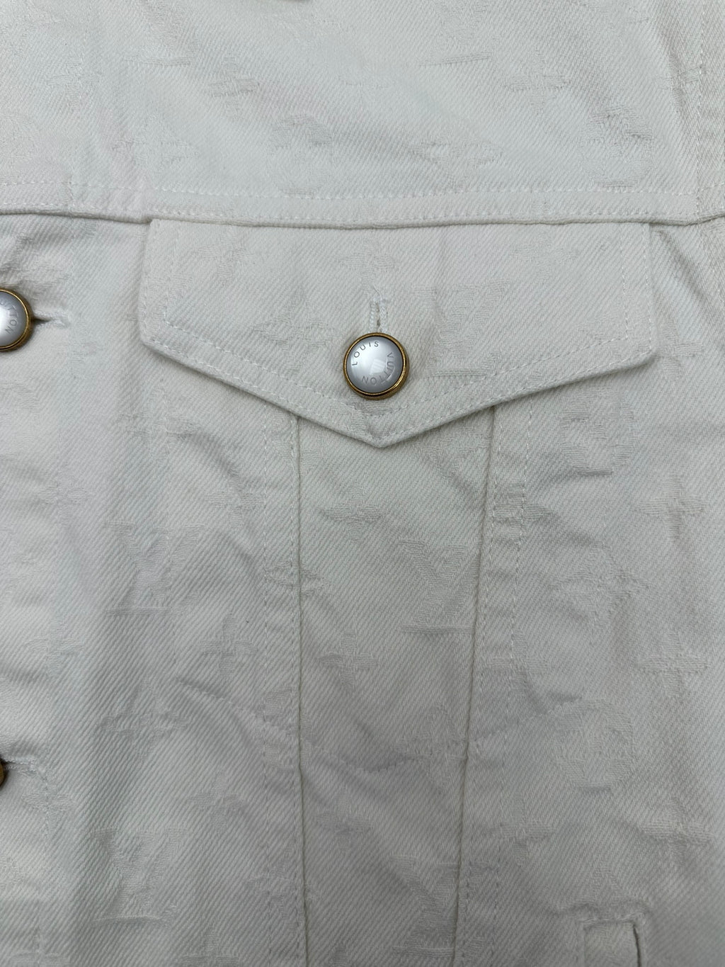 Long white jacket front placket with shield-shaped buttoned panel