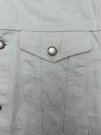 Long white jacket front placket with shield-shaped buttoned panel