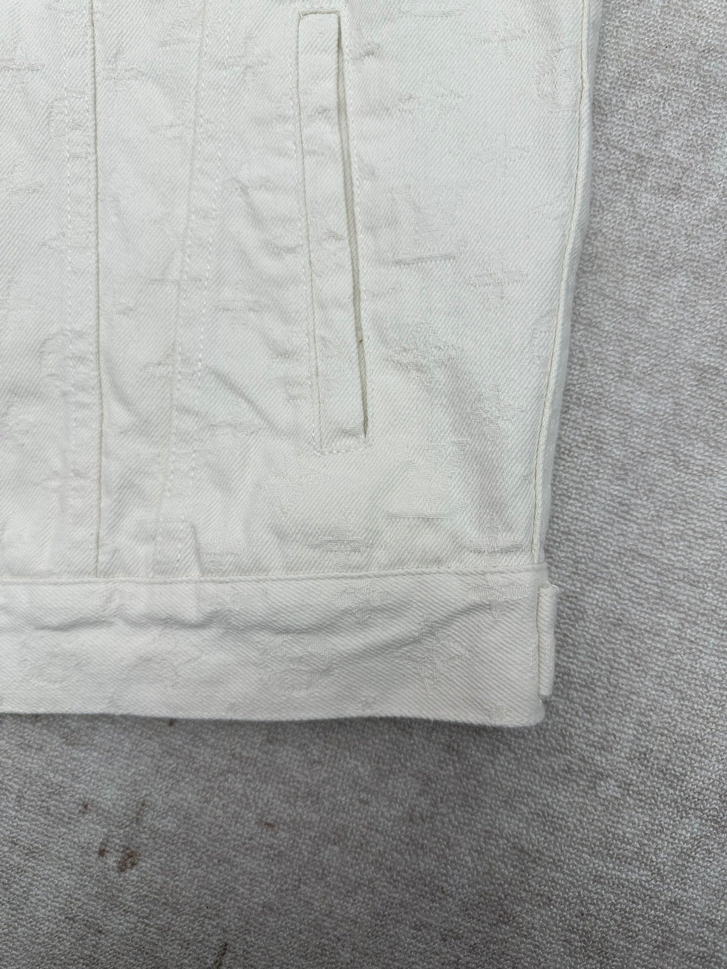 Long white jacket lower back panel with vertical stitched seam
