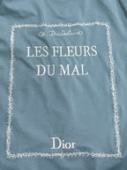 Light blue Dior T-shirt front: “LES FLEURS DU MAI” with decorative stitched border