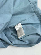 Light blue Dior T-shirt interior neck label on folded fabric