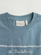 Light blue Dior T-shirt neckline with “LES FLEURS DU MAI” embroidery