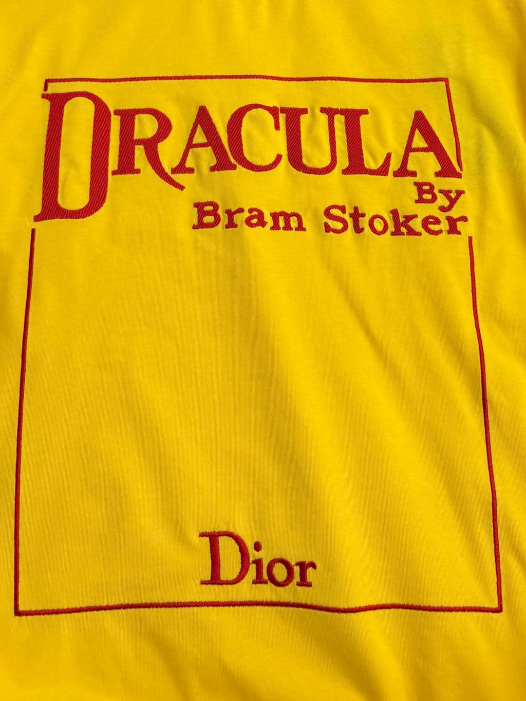 Yellow short-sleeve T-shirt front panel with red 'DRACULA' and 'Dior' print