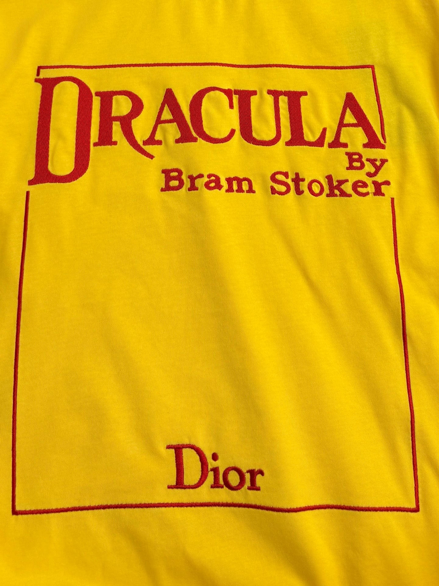 Yellow short-sleeve T-shirt front panel with red 'DRACULA' and 'Dior' print