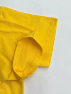 Yellow T-shirt sleeve cuff with stitched seam detail