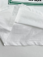 White Dior T-shirt hem with green-trim edge and stitching