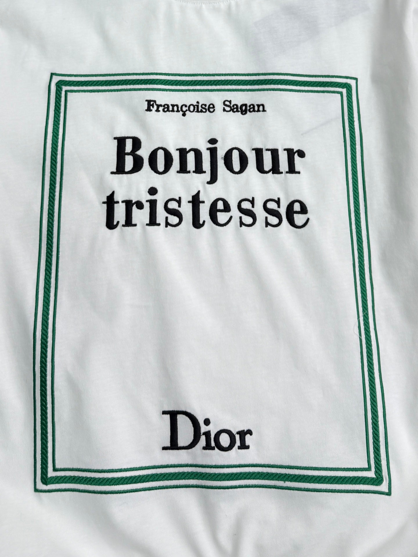 White Dior T-shirt front graphic: Bonjour tristesse with green border