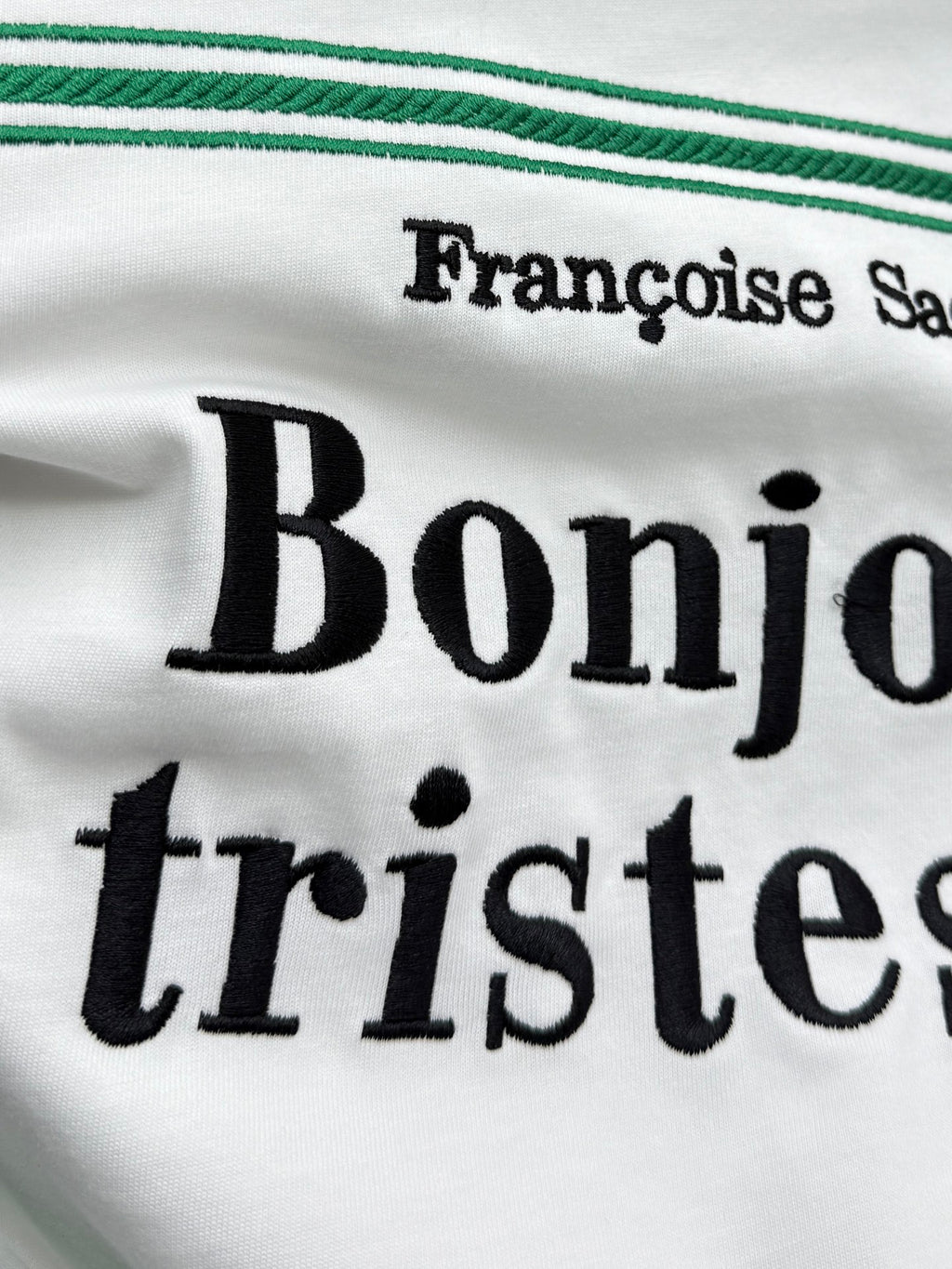 White Dior T-shirt close-up of large black Bonjour tristesse lettering