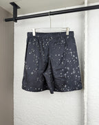 Black patterned shorts with elastic waistband and all-over white motif