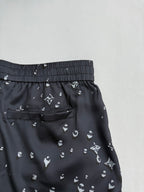 Black patterned shorts with patch pocket and elastic waistband