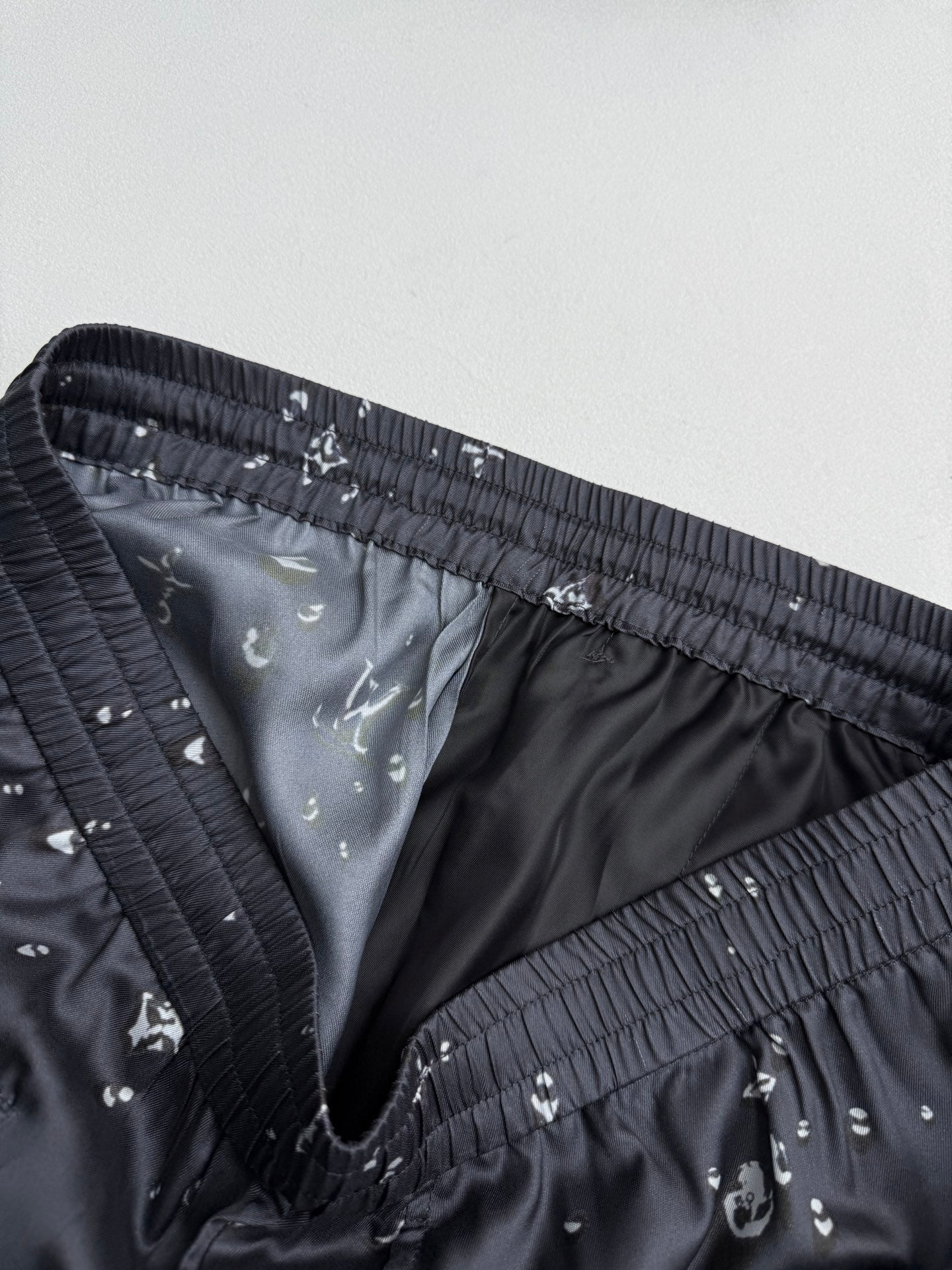 Black patterned shorts inner lining with elastic waistband and stitched seams