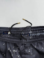 Black shorts waistband close-up with drawstring and inner fabric label