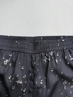 Black shorts waistband with gathered elastic and all-over white motif print