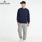 Navy Stone Island crewneck sweatshirt with sleeve patch, with light gray sweatpants