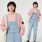 Stone Island pink sweatshirt with denim overalls and blue straps