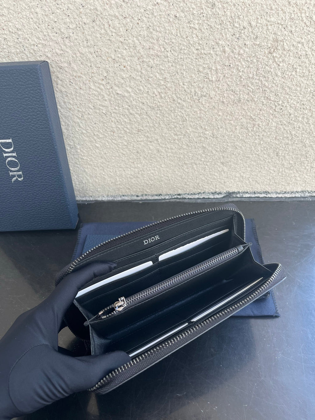 Dior small zip wallet bag open to reveal card slots and inner compartments