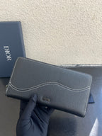 Dior small zip wallet bag in dark textured leather with Dior logo patch